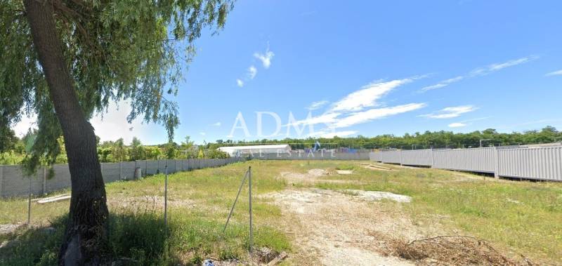 Plots - commercial in Nitra, grassy area with fencing and blue sky.