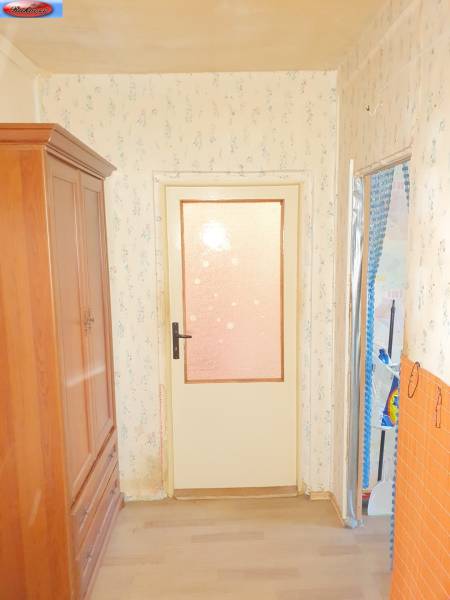 Wooden cabinet and doors with glazing in a 2-room apartment.