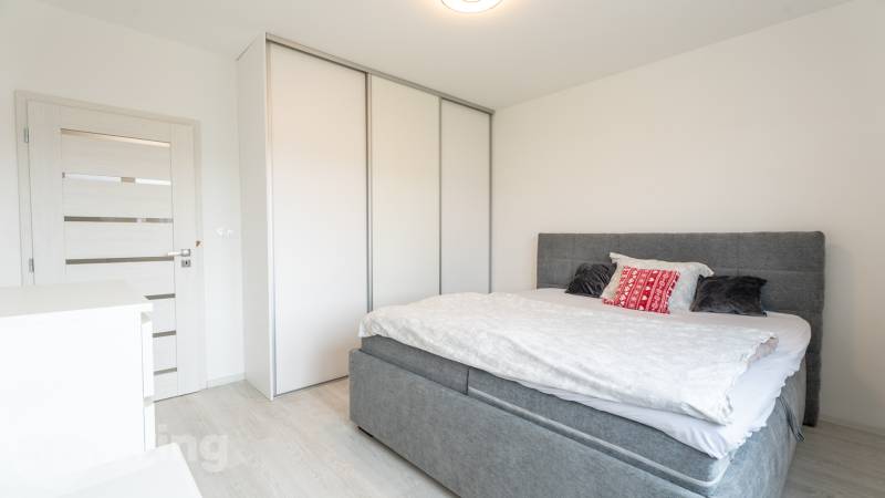 Bedroom in a 3-room apartment with a bed, wardrobe, and light-colored door.