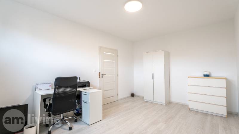 A workspace in a 3-room apartment with a desk, a wardrobe, and a chest of drawers.