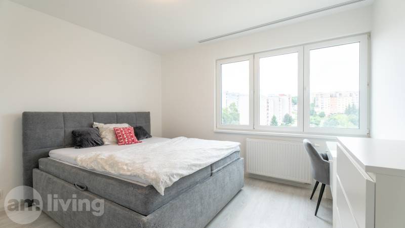 Bright bedroom with a bed and a view in a 3-room apartment.