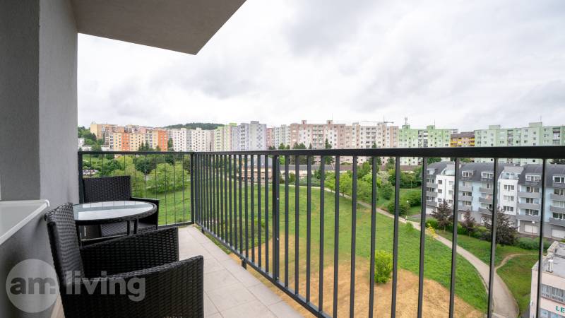 A balcony with a view of the Halalovka housing estate in Trenčín, at a 3-room apartment with outdoor seating.