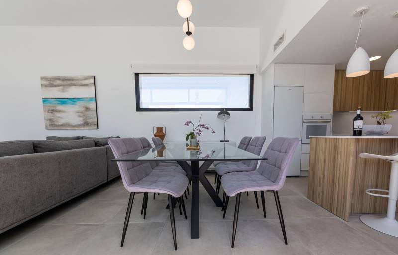 Dining table with a glass top and six chairs in the interior of the Villa.
