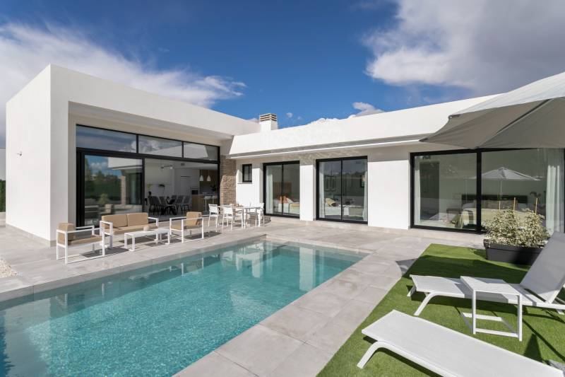 Villa in Calasparra with a pool, terrace, and comfortable outdoor seating under the blue sky.