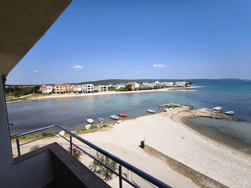 View from a studio apartment in Sukošan with a beach and coastline on the horizon.