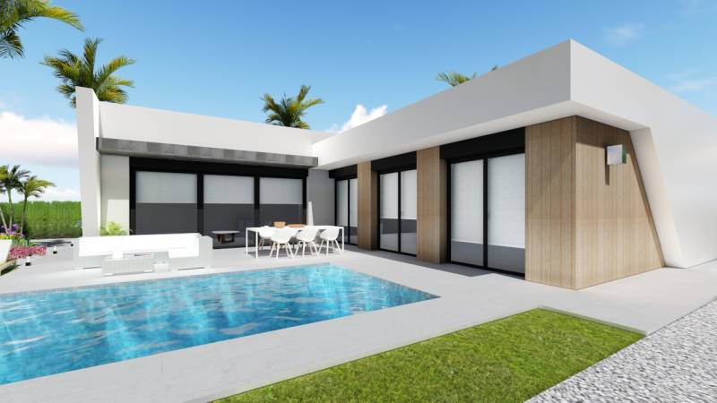 A villa in Calasparra with a pool, outdoor seating, and a garden, surrounded by palm trees.