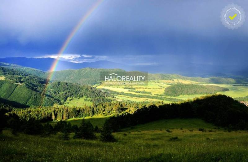A rainbow over the green hills near the cottage in Dolná Lehota.
