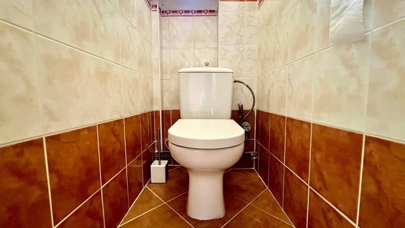 Separate toilet in a 2-room apartment with ceramic tiles and flooring.
