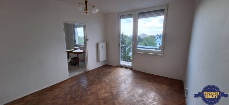 A bright room with parquet floors, a balcony, and an adjoining room in a 3-room apartment.