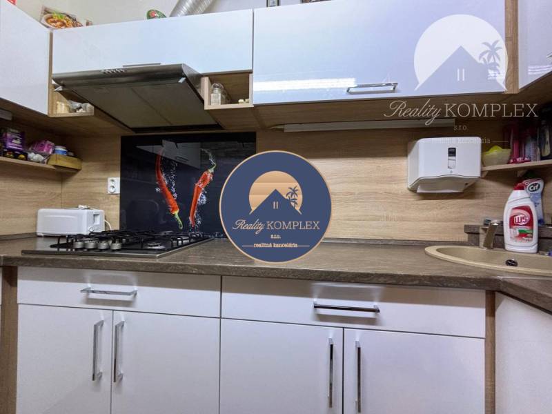 A kitchen in a family house with a gas stove and modern wall decorations.