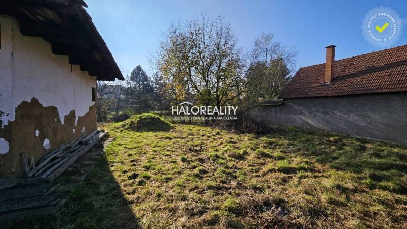 An older house surrounded by a grassy plot, ideal for living in nature.