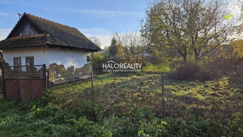 An older house for renovation, surrounded by greenery, suitable for land - living.