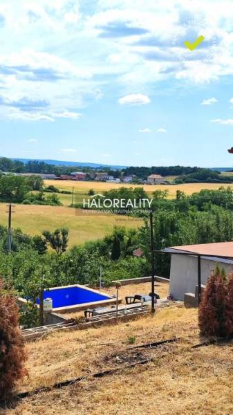 Gardens in Lučenec with a view of the landscape, a swimming pool, and nearby surrounding nature.