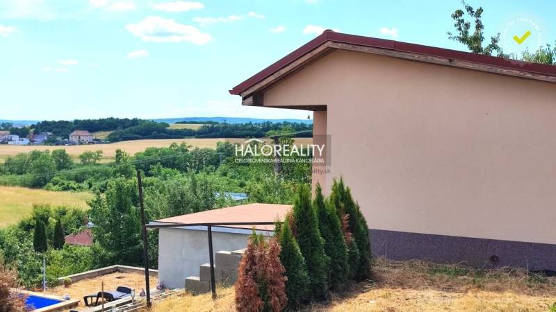 Gardens in Lučenec with a scenery of a rural environment and buildings in the distance.