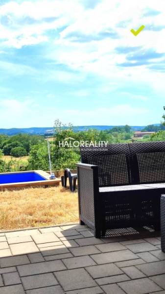 View of the green gardens from the garden in Lučenec with a pool and seating.