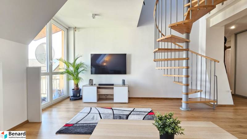 Living room with a television, staircase, and a plant in a 4-room apartment.