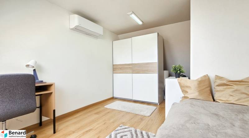 4-room apartment with a desk, sofa, wardrobe, and air conditioning on the wall.