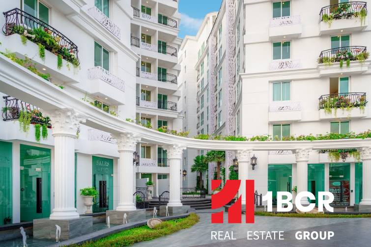 Apartment construction in Pattaya with elegant white buildings and Greek columns.