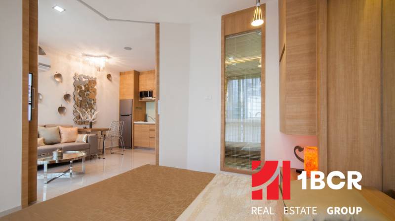 Interior of a 2-room apartment with a view of the living area and kitchen.