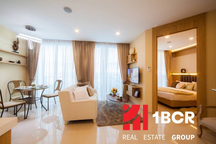 Living room with dining area and entrance to the bedroom in a three-room apartment.
