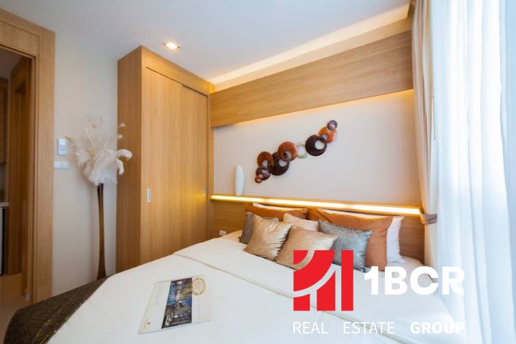 A bedroom in a 3-room apartment with a built-in wardrobe and decorative elements on the wall.