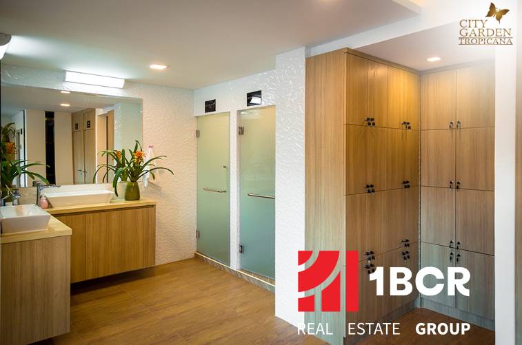 A bathroom with wooden furniture and a sink as part of apartment construction.