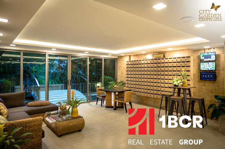 Interior of a living room with comfortable seating, decorations, and mailboxes, apartment construction.