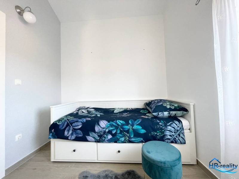 Recreational apartment with a bed and blue patterned bedding.
