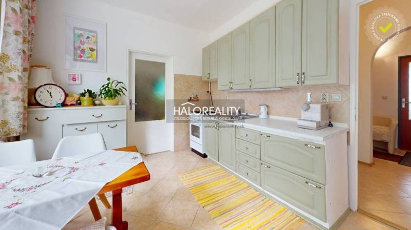 A bright kitchen with cabinets, a dining table, and decorations in a 4-room apartment.