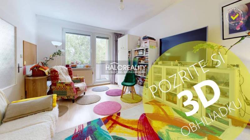 Living room with a light floor, colorful carpet, and comfortable seating in a four-room apartment.