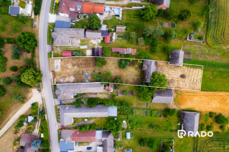 Aerial view of a plot in Chocholná-Velčice, surrounded by houses and gardens. Residential plots.
