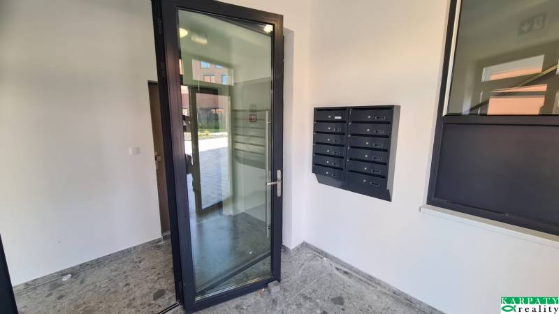 The entrance hall of an apartment building on Perlová Street in Bratislava - Jarovce with mailboxes.