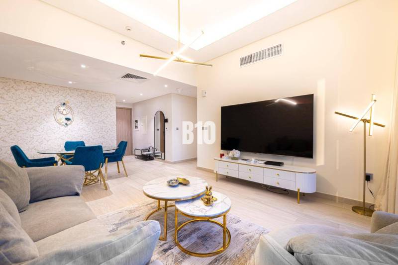 Living room in a 3-room apartment with a sofa, TV, and dining table.