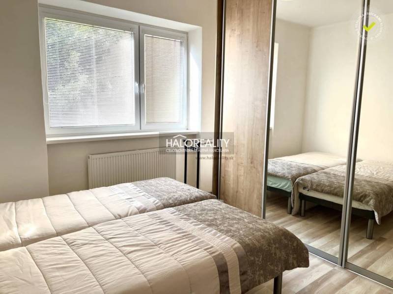 A bedroom in a 3-room apartment with two beds and a built-in wardrobe.
