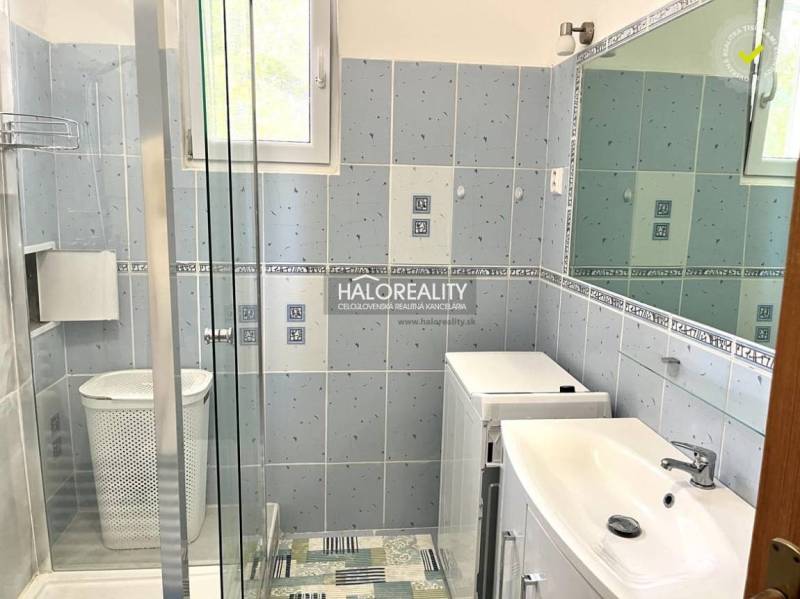 Bathroom in a 3-room apartment with a shower, washing machine, and sink.
