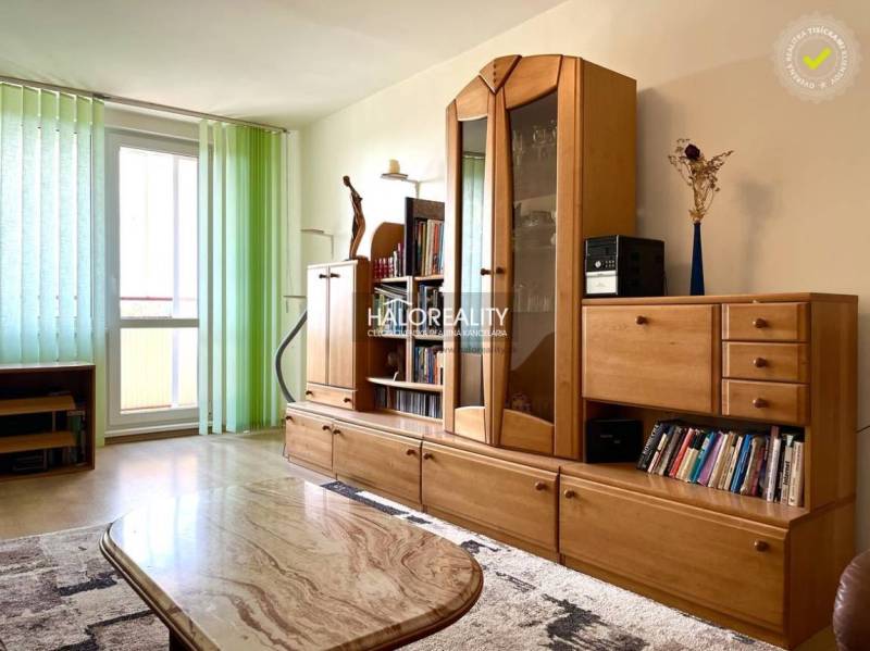 Living room with a wooden wall unit and light in a 3-room apartment.