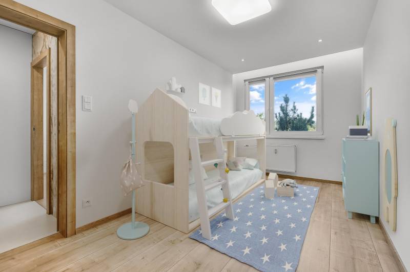 A children's room in a 4-room apartment with a bunk bed and a blue carpet with stars.