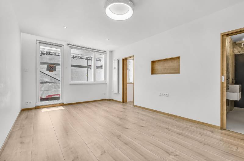 Bright living room with wooden flooring in a 4-room apartment.