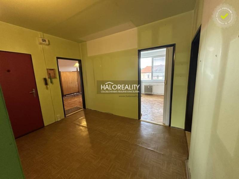 A room with light walls and parquet flooring in a 3-room apartment.