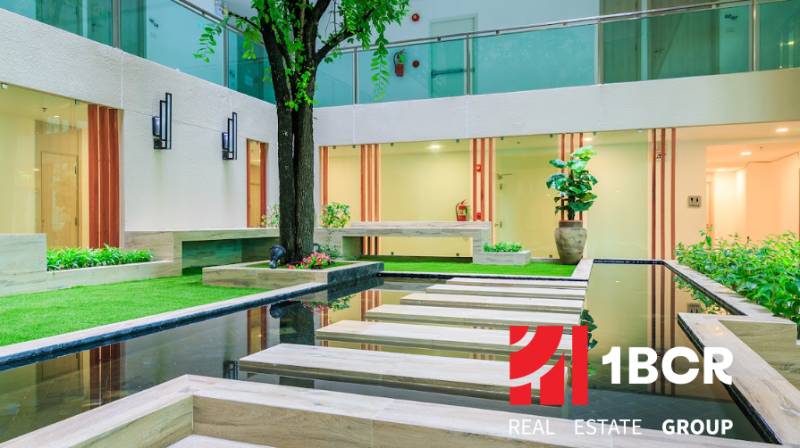 Interior atrium with water feature and greenery, Apartment construction.