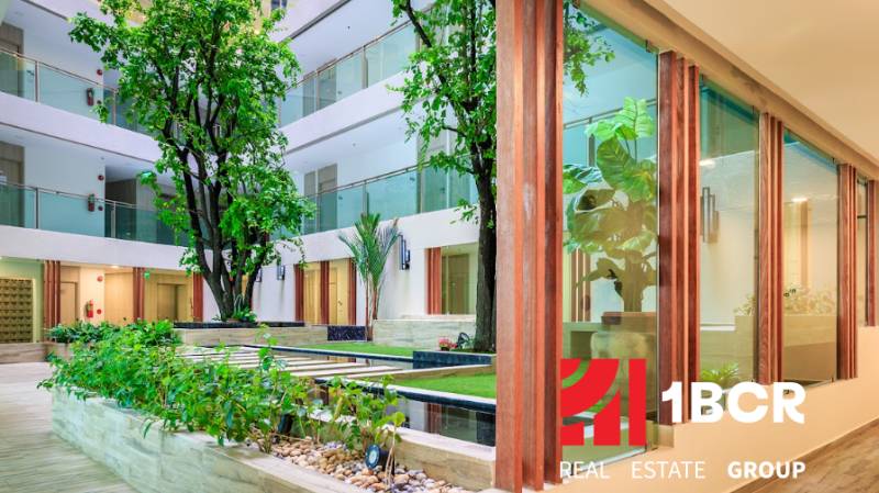 Interior atrium with vegetation and wooden elements, Apartment construction.