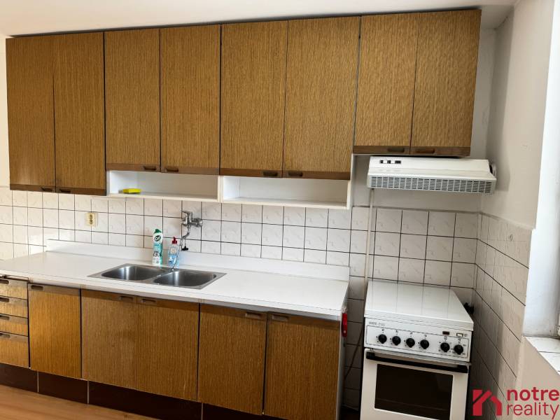 A kitchen with appliances and a sink in a family house.