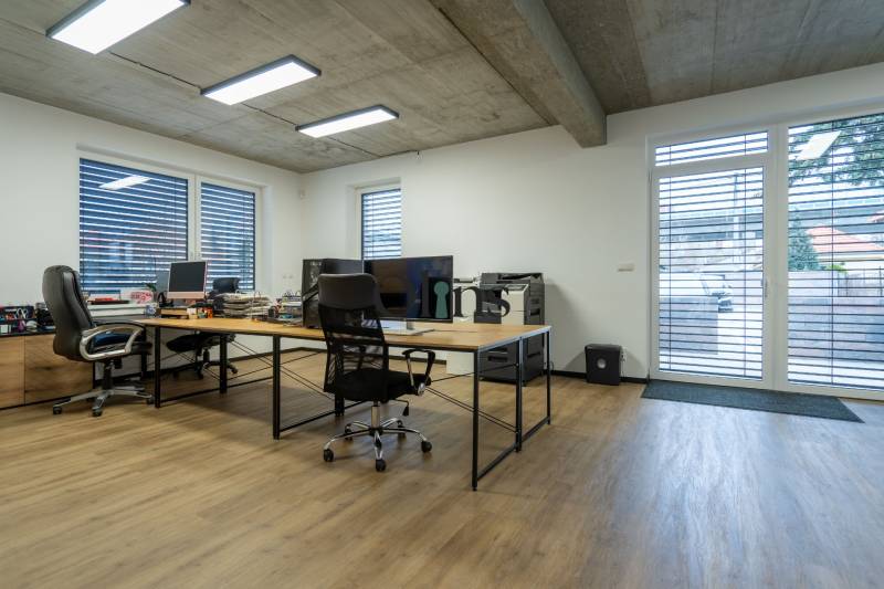 Offices with wooden floors, work desks, and comfortable chairs.