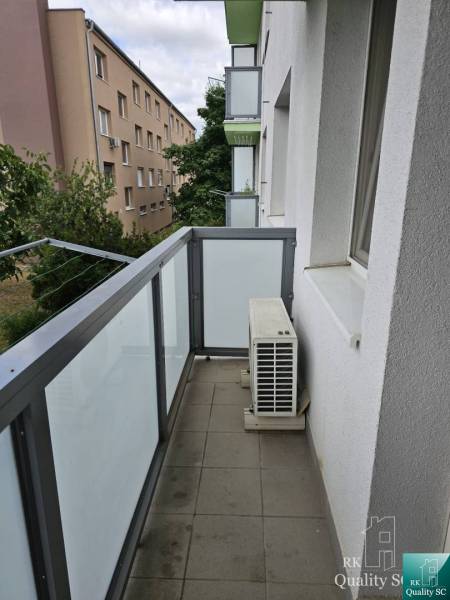 Balcony of a 2-room apartment on Žitavská Street in Senec with a railing and an air conditioning unit.