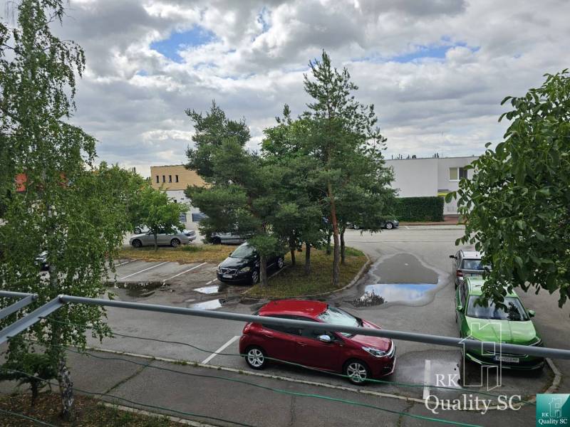 Parking lot on Žitavská Street in Senec with cars and trees.