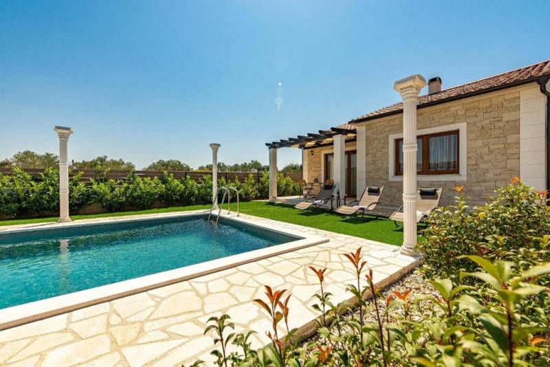 A family house in Bibinje with a pool, terrace, and sun loungers in the garden.