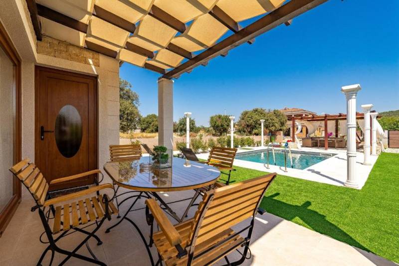 A family house in Bibinje with a terrace and a view of the pool and garden.