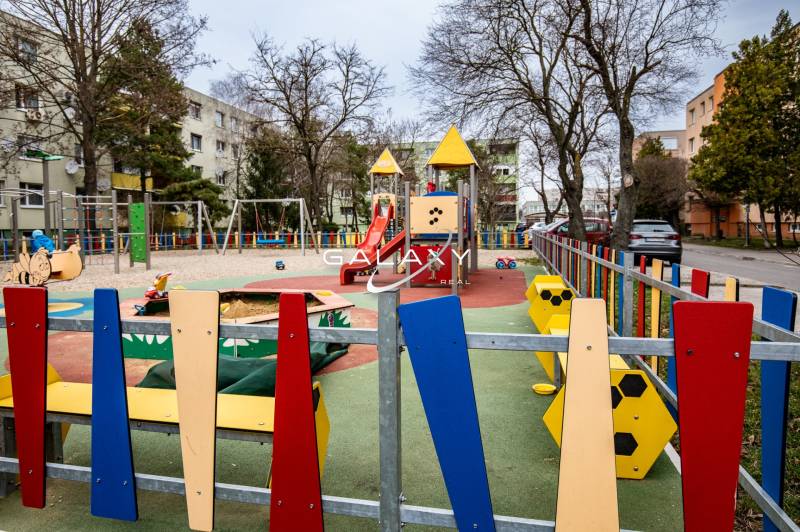 Playground on Boriny Street, near a 3-room apartment, with swings and a slide.