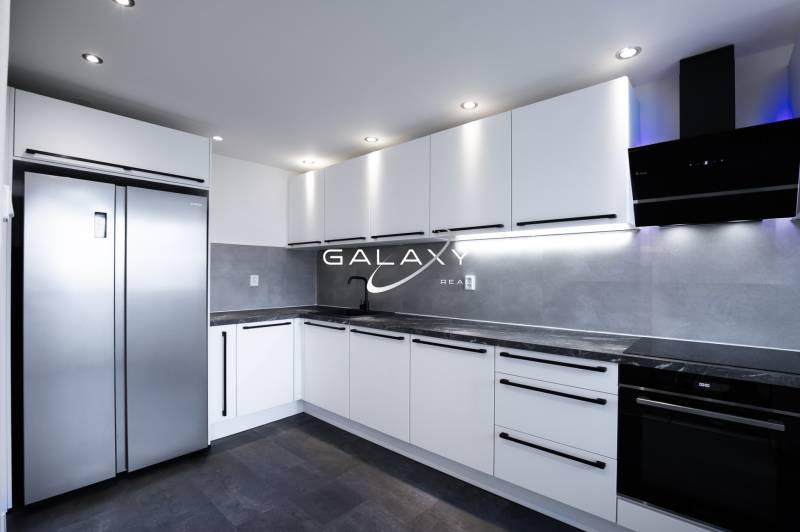 The kitchen in a 3-room apartment on Boriny Street with gray and white elements.