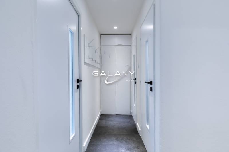 A narrow hallway with white doors in a 3-room apartment on Boriny Street.